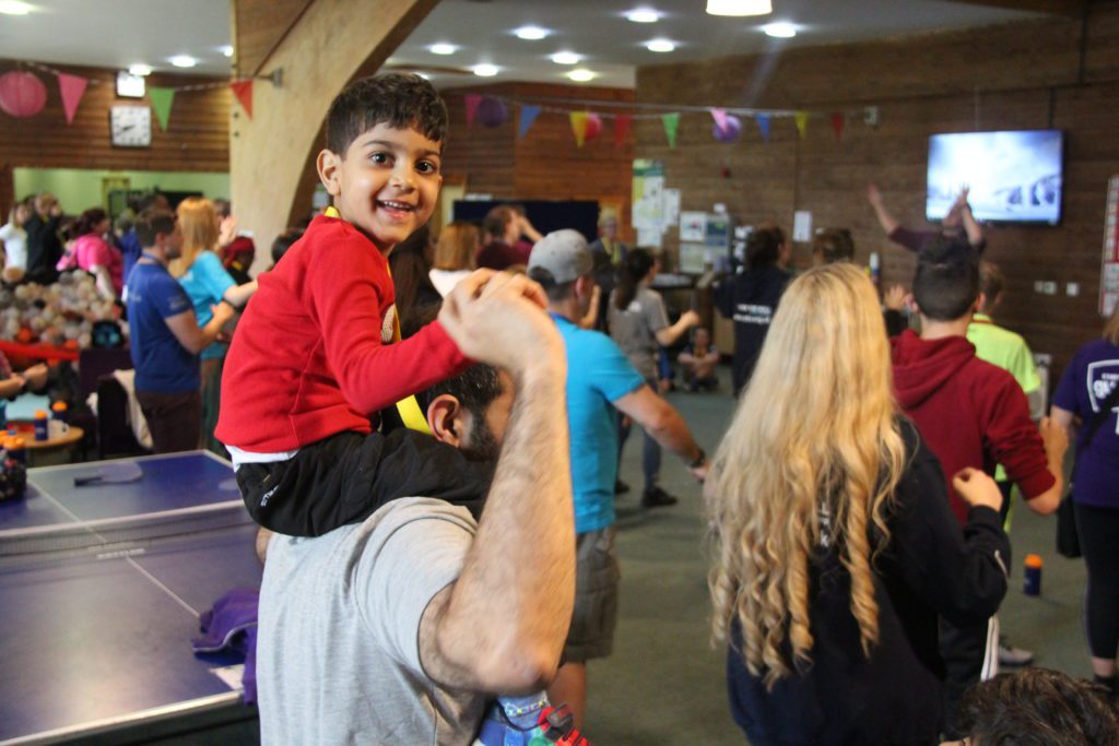 Little boy on carers shoulders at Family Camp