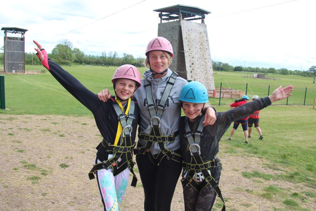 Family of 3 getting ready to climb the tower a Over The Wall Camp