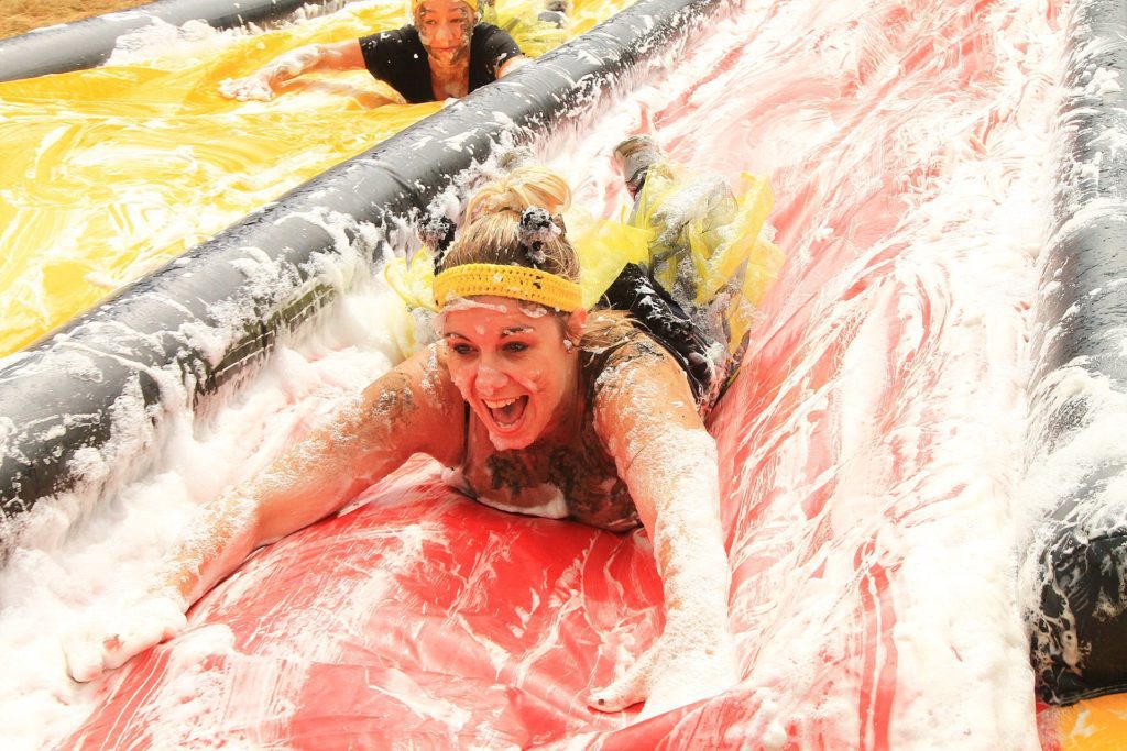 Woman on waterslide while fundraising for Over The Wall