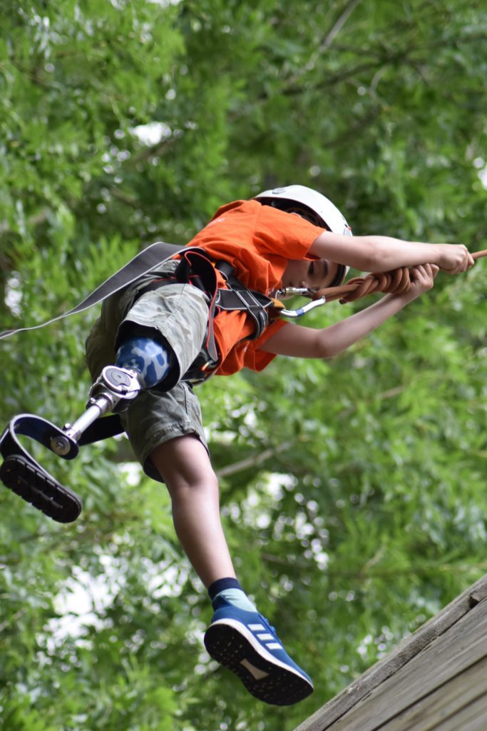Camper on zip wire at Over The Wall Camp