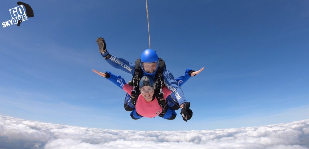 Man and woman skydiving for Over The Wall