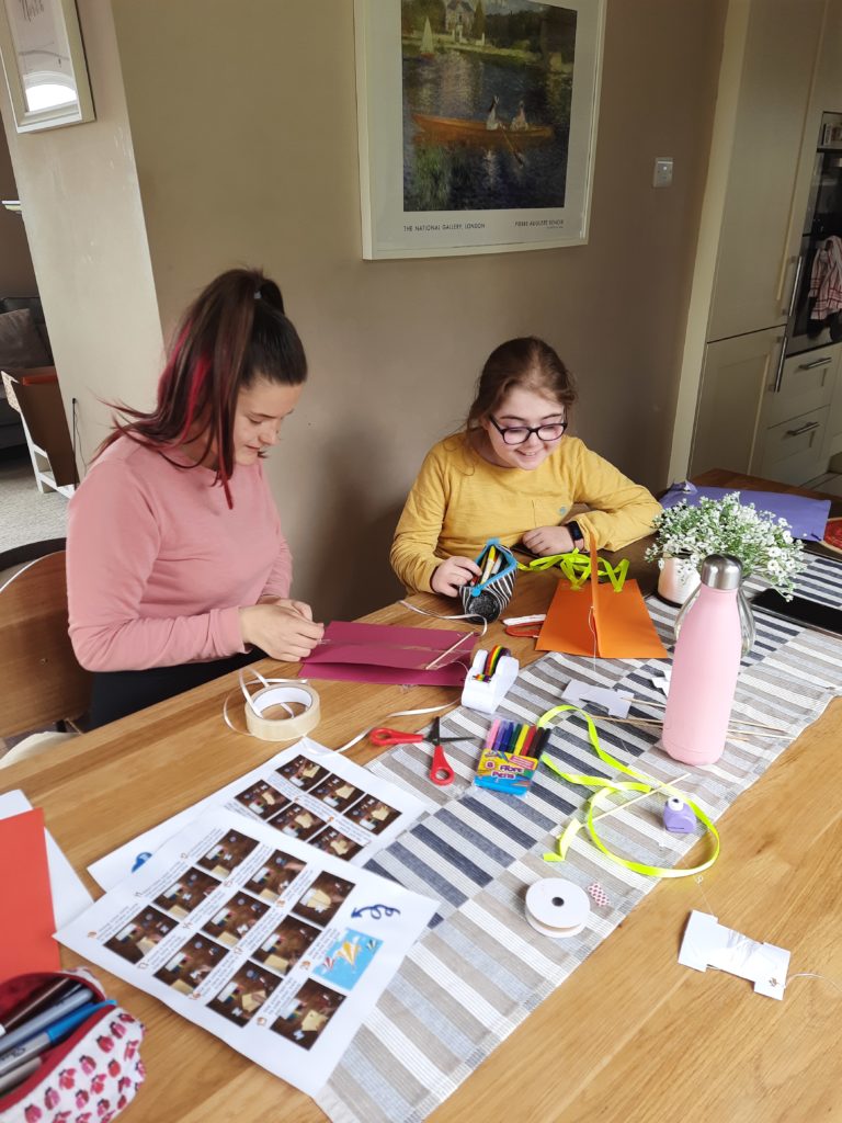 Family making kites during Camp in the Cloud