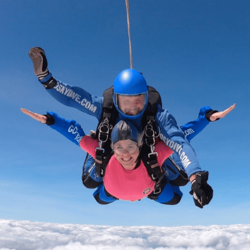 Man and woman skydiving for Over The Wall