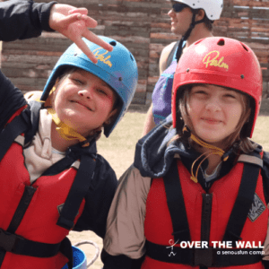 Two campers in helmets for kayaking at an Over The Wall Camp
