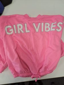 Pink t-shirt with "Girl Vibes" on the front