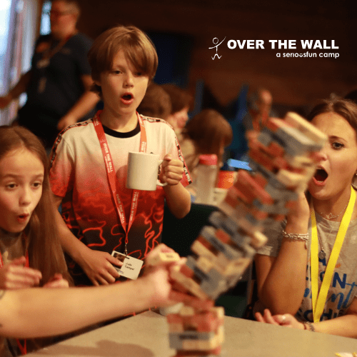 Family playing Jenga at Over The Wall Family Camp 2023