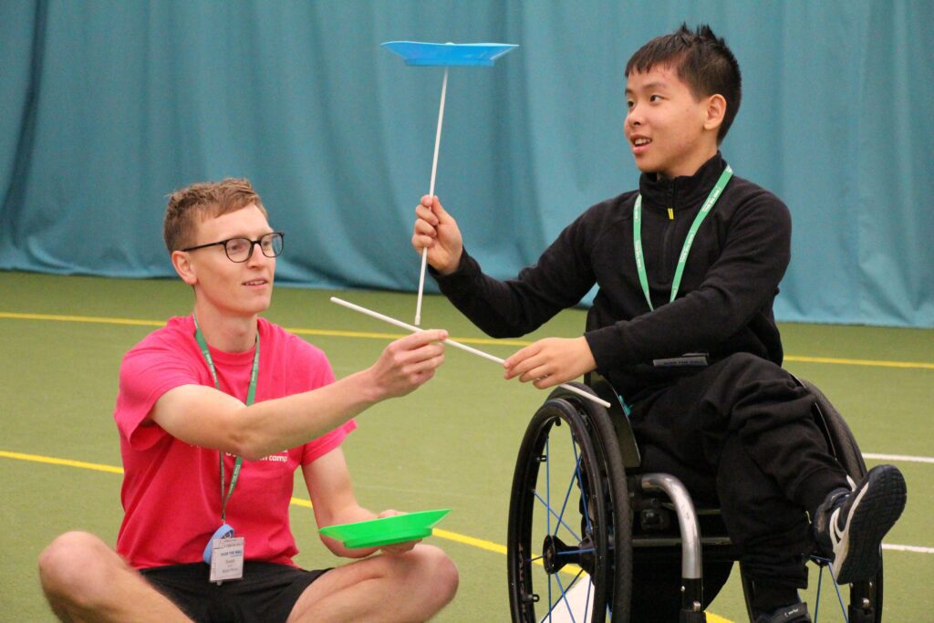 clinical volunteer with camper at residential activity camp