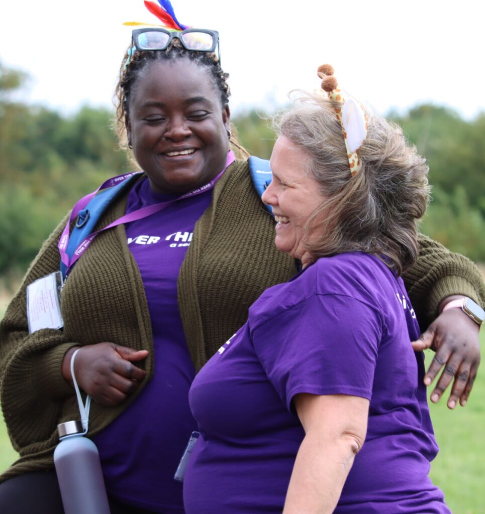 Two Over The Wall Volunteers in purple tops