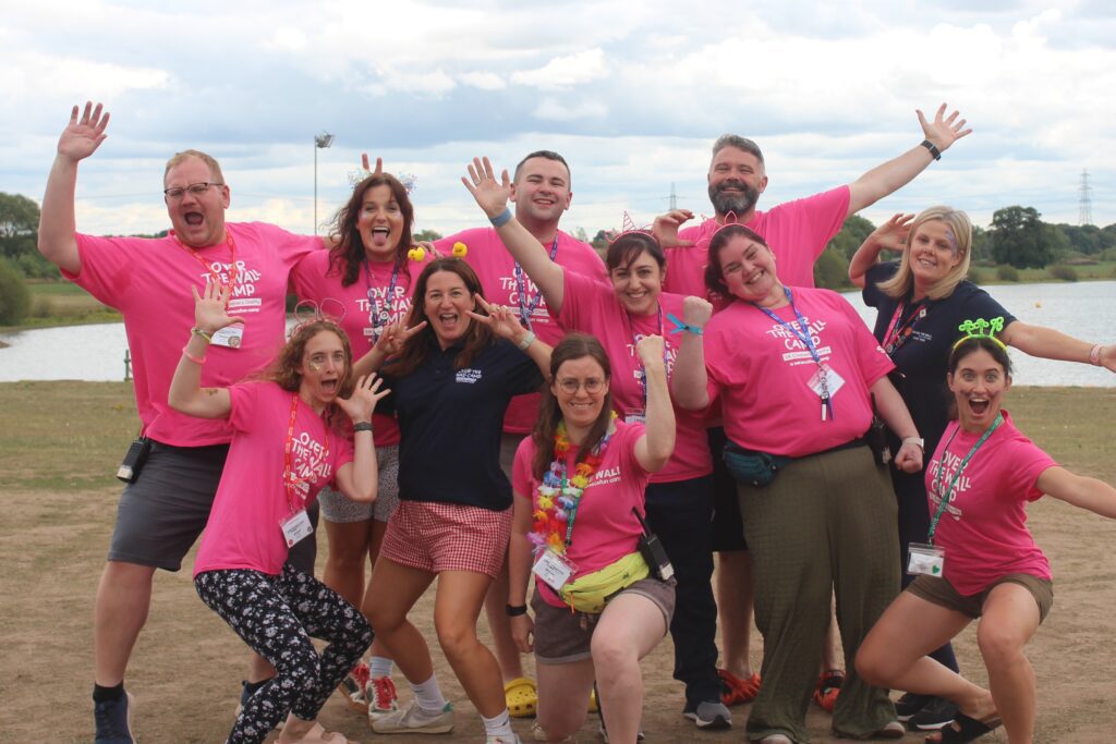 Group of smiley volunteers in pink t-shirts