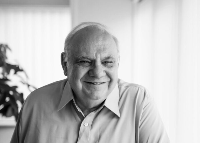 Black and white photo of an older gentleman in a shirt, smiling