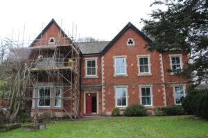 Red brick building with scaffolding outside under construction