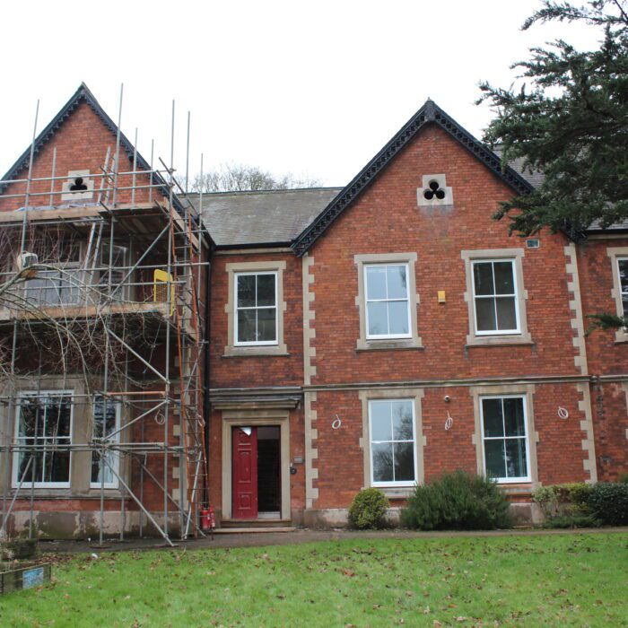 Red brick building with scaffolding outside under construction